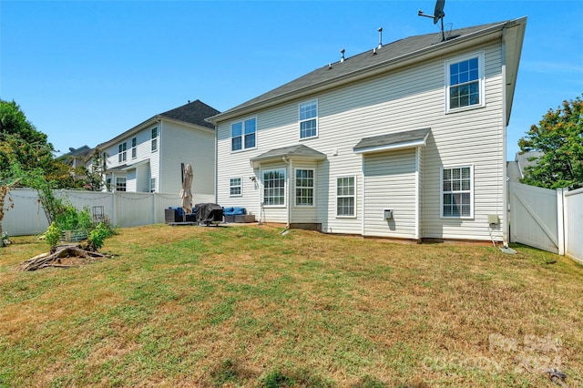 back of property featuring a fenced backyard and a yard