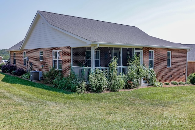 rear view of property with a lawn and central AC unit