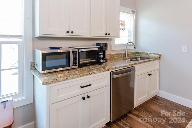 kitchen with sink, appliances with stainless steel finishes, dark hardwood / wood-style flooring, and white cabinets