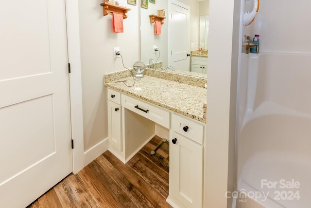 bathroom with vanity and wood-type flooring