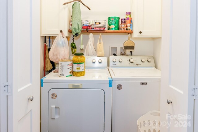 laundry room featuring cabinets and washing machine and dryer