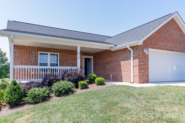 ranch-style home with a garage and a front lawn