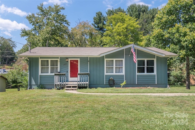 single story home with covered porch and a front lawn