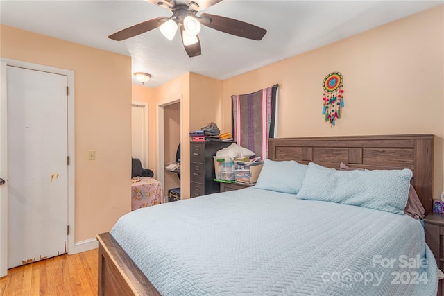 bedroom with ceiling fan and light hardwood / wood-style flooring