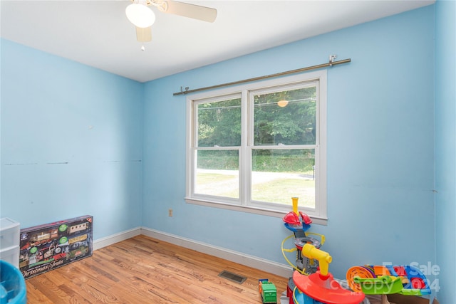 recreation room featuring light hardwood / wood-style flooring and ceiling fan