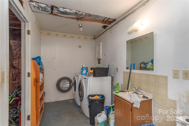 clothes washing area featuring independent washer and dryer