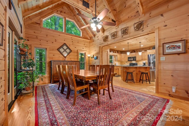 dining room with wooden ceiling, beamed ceiling, high vaulted ceiling, and light hardwood / wood-style floors