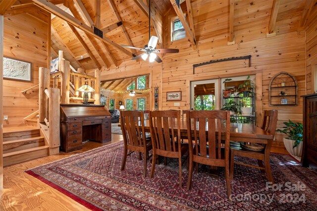 dining area featuring beamed ceiling, wooden ceiling, high vaulted ceiling, hardwood / wood-style flooring, and ceiling fan