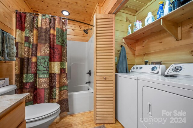 laundry room with wood ceiling, light hardwood / wood-style flooring, independent washer and dryer, and wooden walls