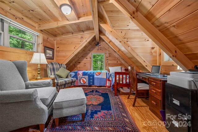 interior space featuring light wood-type flooring, wood ceiling, wood walls, and vaulted ceiling with beams