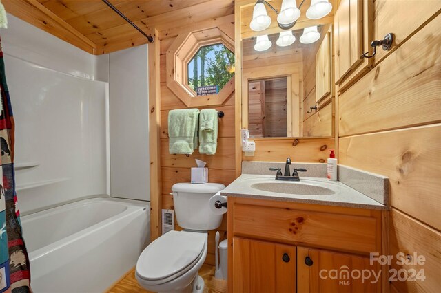 full bathroom with vanity, wood walls, shower / tub combo with curtain, wood ceiling, and toilet