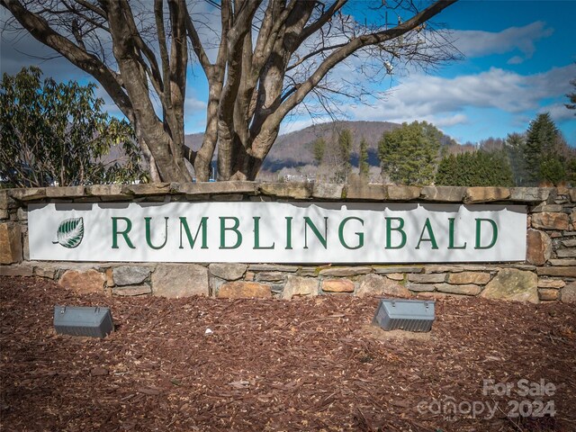 community / neighborhood sign with a mountain view