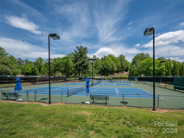 view of sport court with a lawn