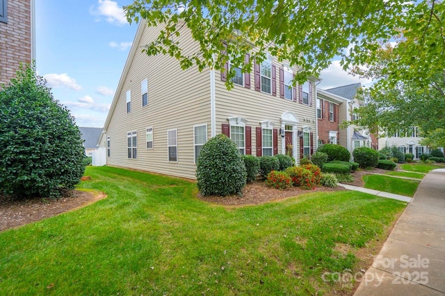 view of property exterior with a yard