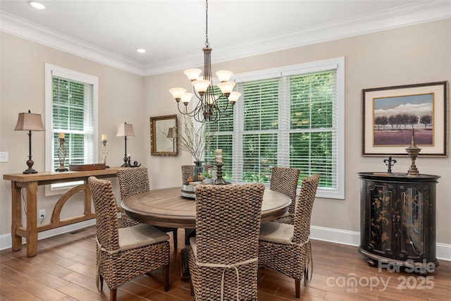 dining area with crown molding and a chandelier