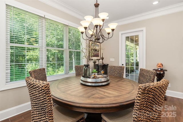 dining area with a chandelier, baseboards, dark wood-style floors, and crown molding