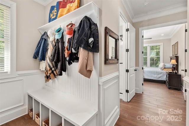 mudroom with crown molding and hardwood / wood-style flooring