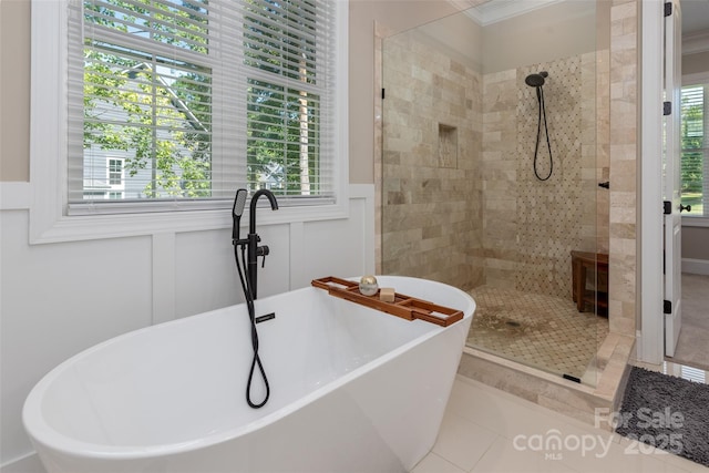 bathroom featuring tile patterned flooring, crown molding, and shower with separate bathtub