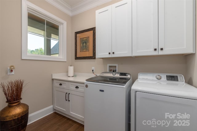 laundry room featuring dark wood finished floors, cabinet space, separate washer and dryer, crown molding, and baseboards