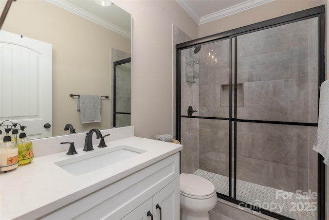 bathroom with vanity, toilet, a stall shower, and ornamental molding