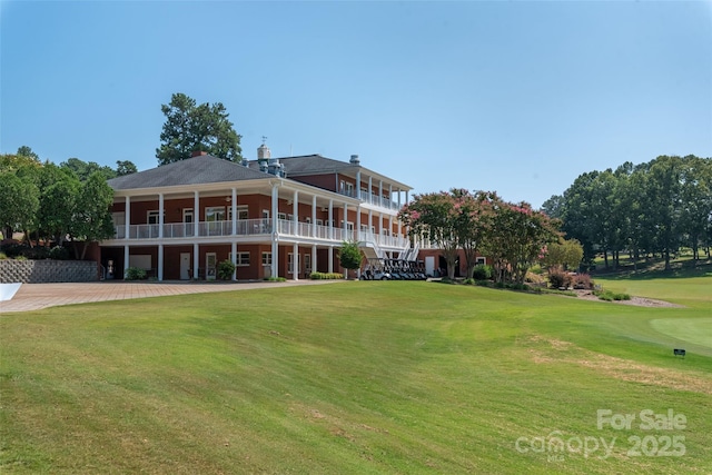 rear view of property with a lawn