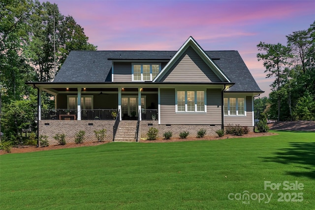 view of front of home with crawl space, a porch, a shingled roof, and a front lawn