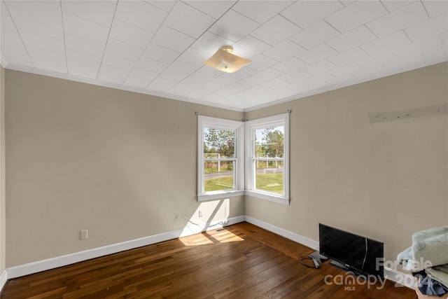 interior space with dark hardwood / wood-style flooring and ornamental molding