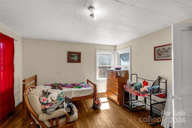 bedroom with dark wood-type flooring