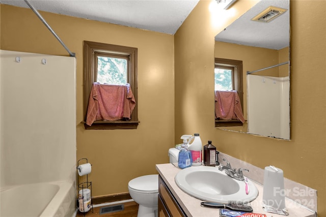 full bathroom featuring a wealth of natural light, vanity, toilet, and washtub / shower combination