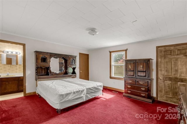 unfurnished bedroom featuring ornamental molding, ensuite bath, sink, and carpet floors