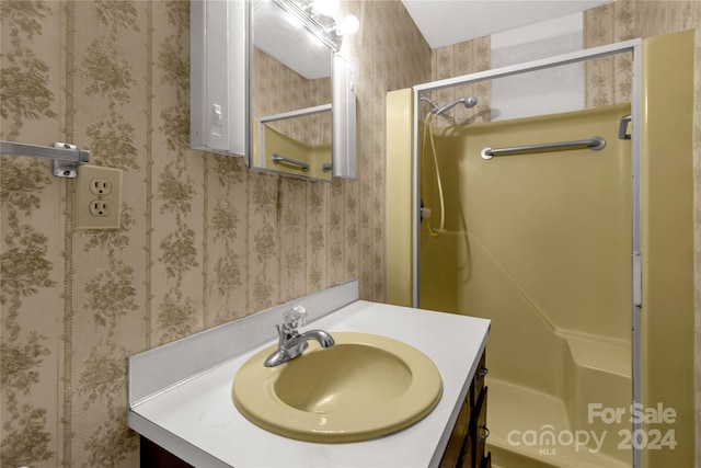 bathroom featuring vanity and an enclosed shower