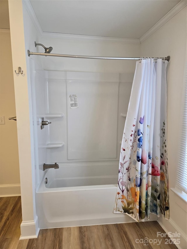 bathroom featuring ornamental molding, wood-type flooring, and shower / bathtub combination with curtain