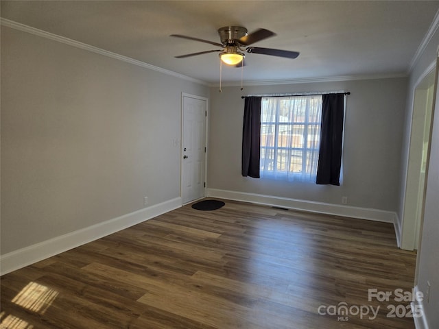 spare room featuring ornamental molding, ceiling fan, and dark hardwood / wood-style flooring