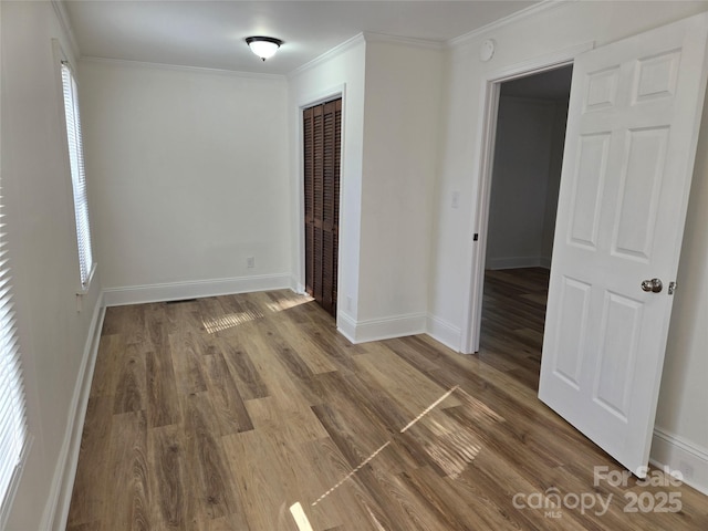 unfurnished room featuring dark hardwood / wood-style flooring and crown molding