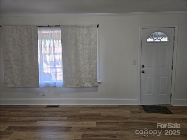 foyer with crown molding, dark hardwood / wood-style floors, and a healthy amount of sunlight