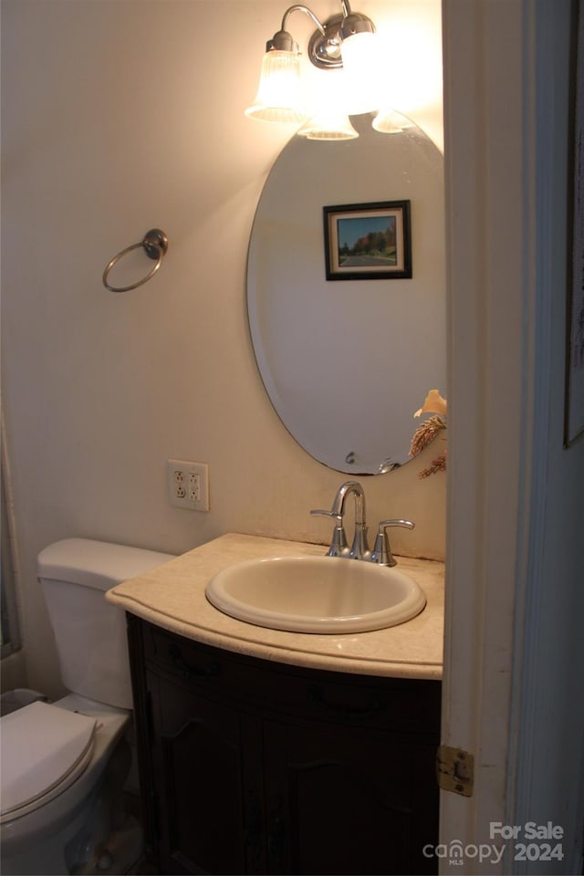 bathroom with toilet and vanity