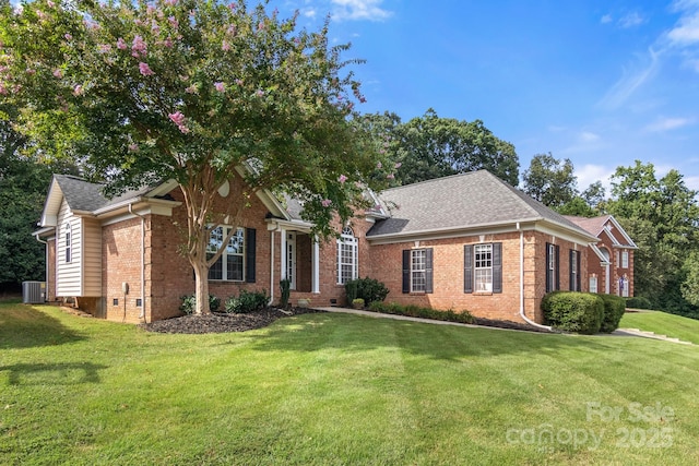 ranch-style home with central air condition unit, brick siding, roof with shingles, and a front lawn