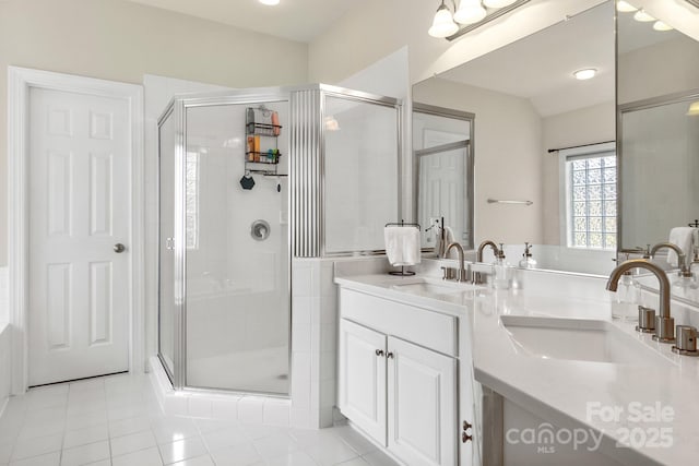 full bathroom featuring vanity, a shower stall, and tile patterned flooring