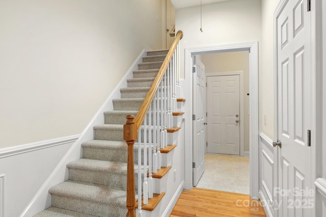 stairs featuring wood finished floors