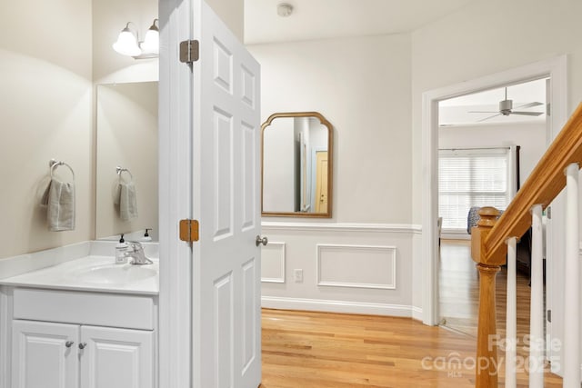 bathroom featuring a ceiling fan, vanity, and wood finished floors