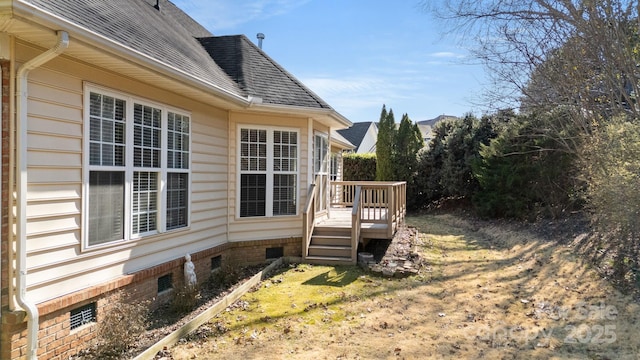view of home's exterior featuring crawl space, roof with shingles, and a wooden deck