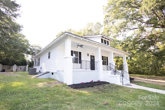 view of front of property with ceiling fan, a porch, central AC unit, and a front lawn