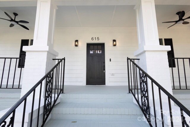 entrance to property with covered porch and ceiling fan