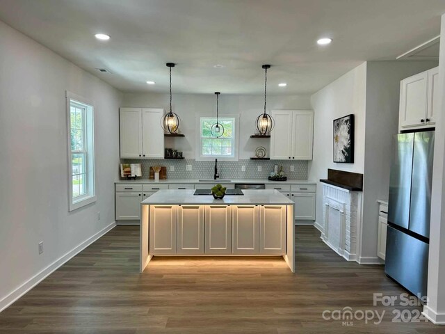 kitchen featuring plenty of natural light, stainless steel refrigerator, and dark hardwood / wood-style flooring