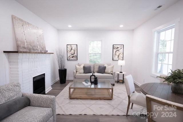 living room featuring light hardwood / wood-style flooring and a fireplace