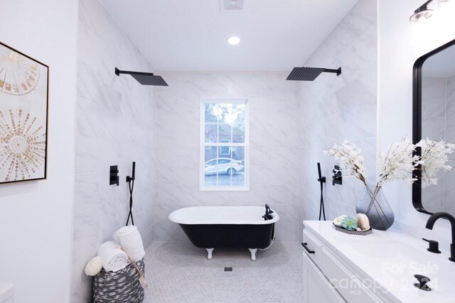 bathroom with vanity and tile walls