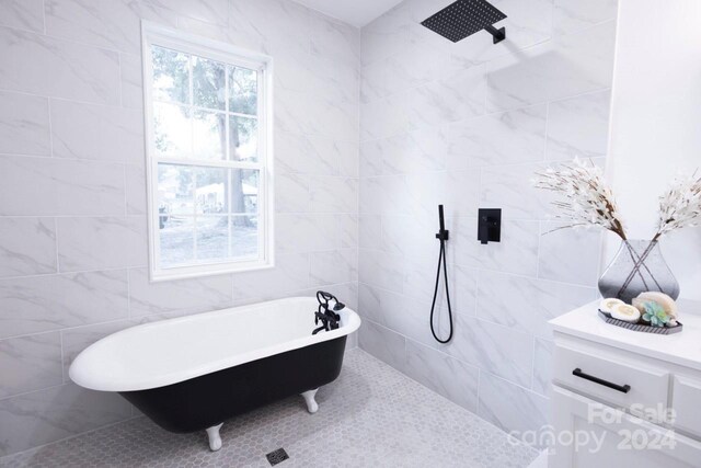 bathroom featuring tile walls, separate shower and tub, and plenty of natural light