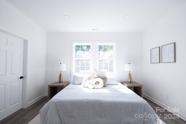 bedroom with dark wood-type flooring