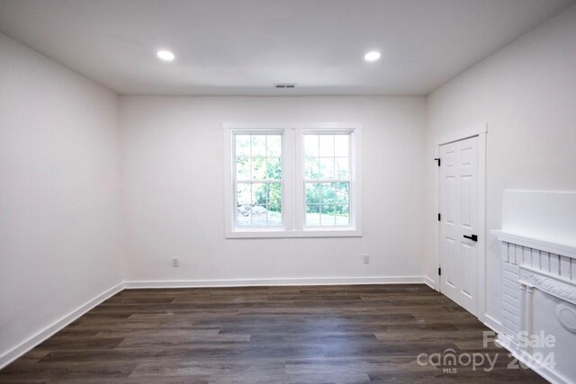 empty room featuring dark wood-type flooring