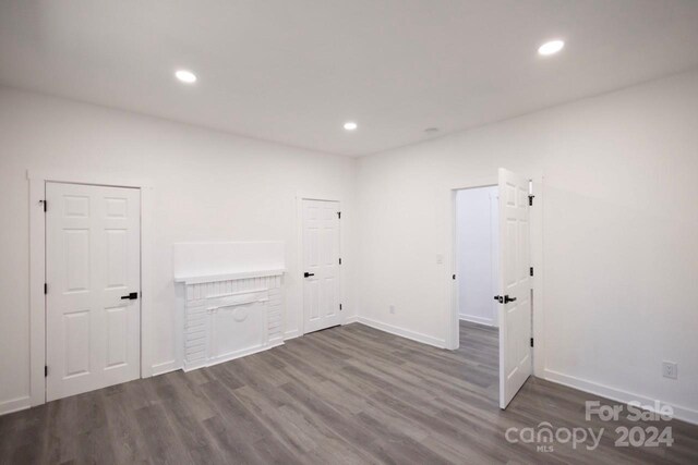 clothes washing area with dark hardwood / wood-style floors